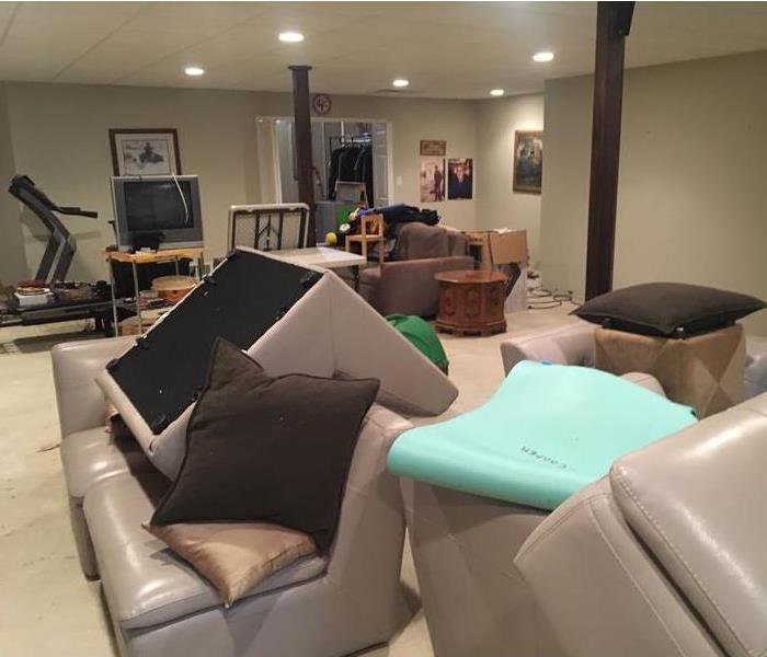Large family room with furniture piled in center