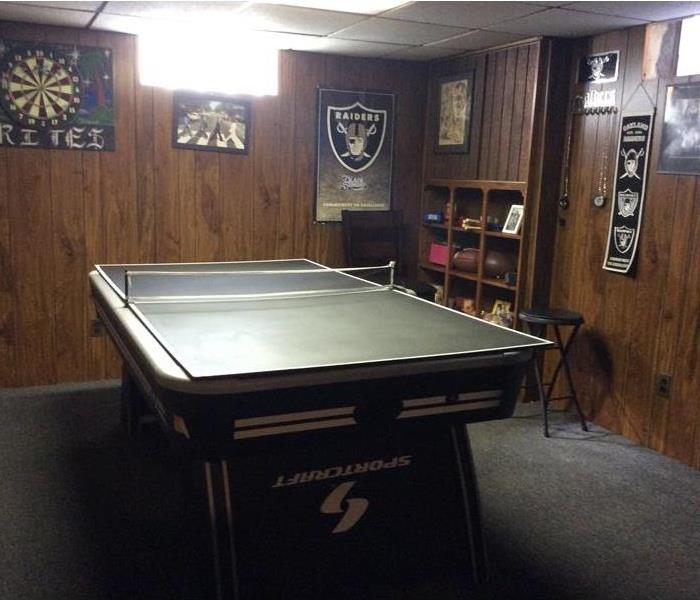 Organized basement with pool table cleared of clutter