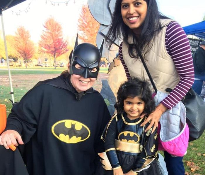 Little girl and Adult in Batman costumes