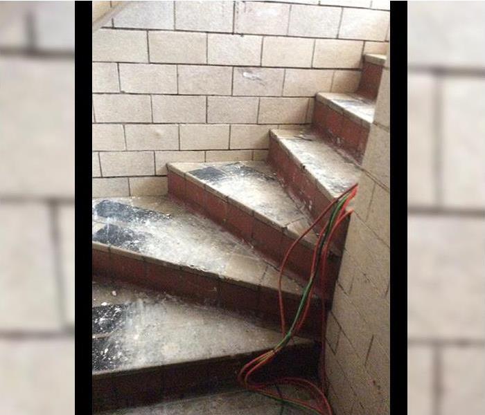Basement stairs covered in flood debris