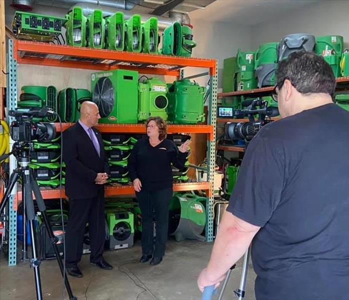 Mayor Bazzi and Franchise Owner talking in front of Servpro equipment